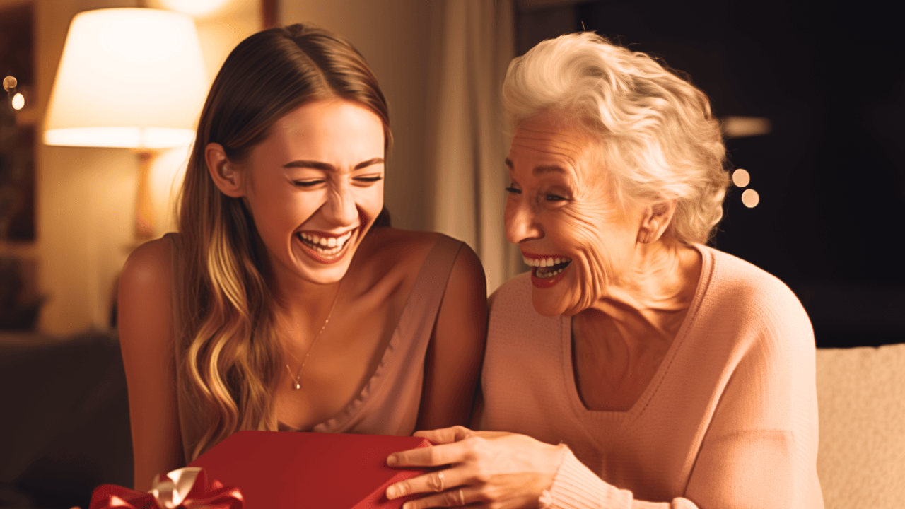 Gifts for Grandmas Collection. Personalized gifts for grandmothers. Image features grandmother receiving gift from adolescent granddaughter. Both joyously smiling.